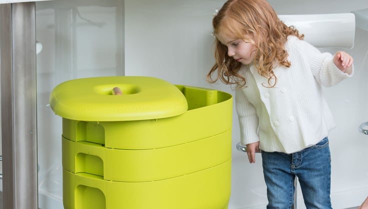  Child looking into a worm composting bin