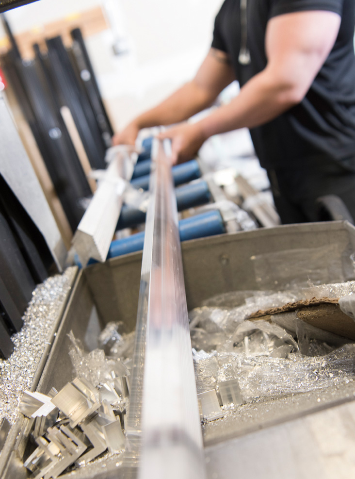 Machinist cutting aluminum corners to size