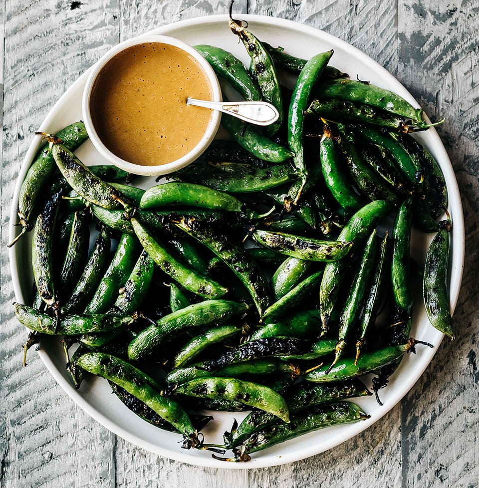 Bowl of Grilled Sugar Snap Peas with Spicy Peanut Sauce