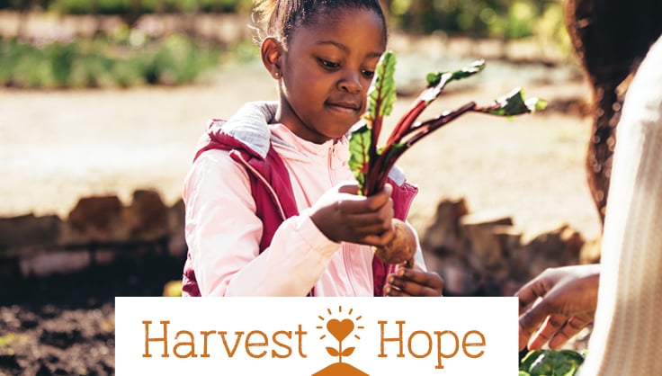 Harvest Hope with child holding raddish