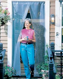 Happy woman walking out of doorway with hands-free bug screen hanging in it