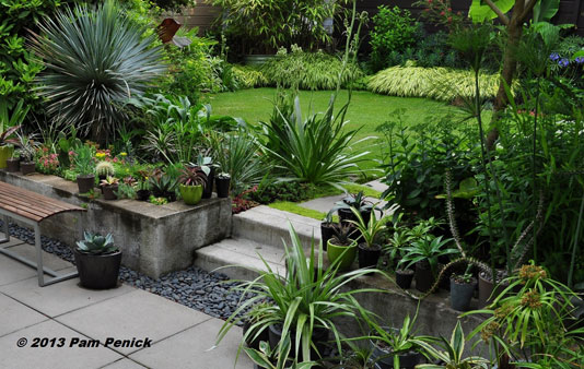 Create a calm oasis of lawn amid a lushly planted garden