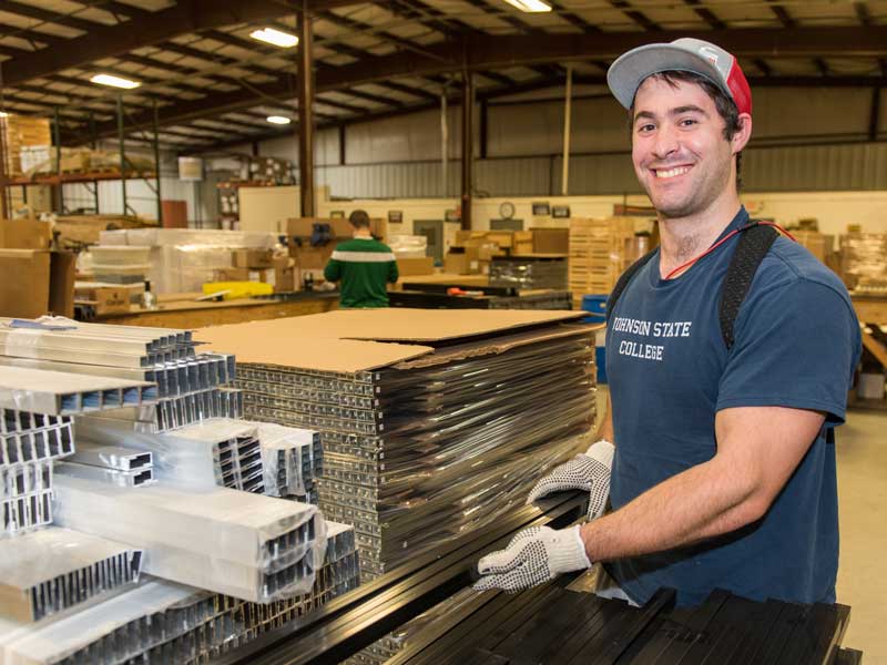 Employee smiling in front of building supplies