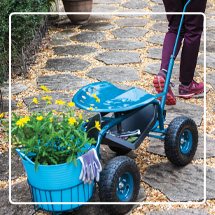 Storm blue Tractor Scoot with Tubtrug being pulled along a path of stepping stones
