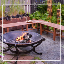 Ashland Firepit with fire burning inside on an outdoor patio