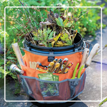 Womanswork Bucket Caddy on stone walkway filled with garden supplies